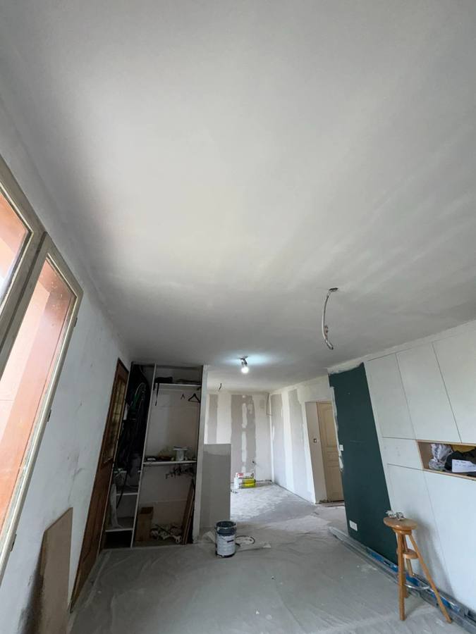 Première passe de ratissage d'un plafond à Besançon – RUSHITI Rénovation, plâtrerie